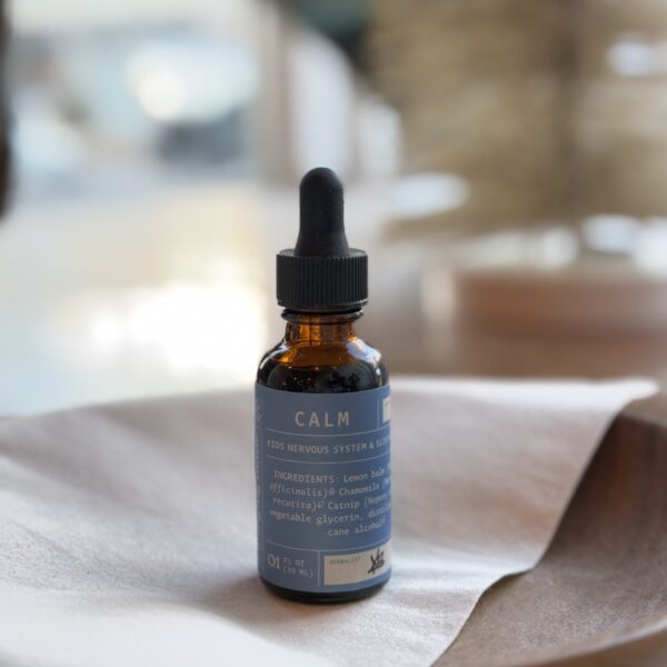 calm kids tincture on wooden bowl