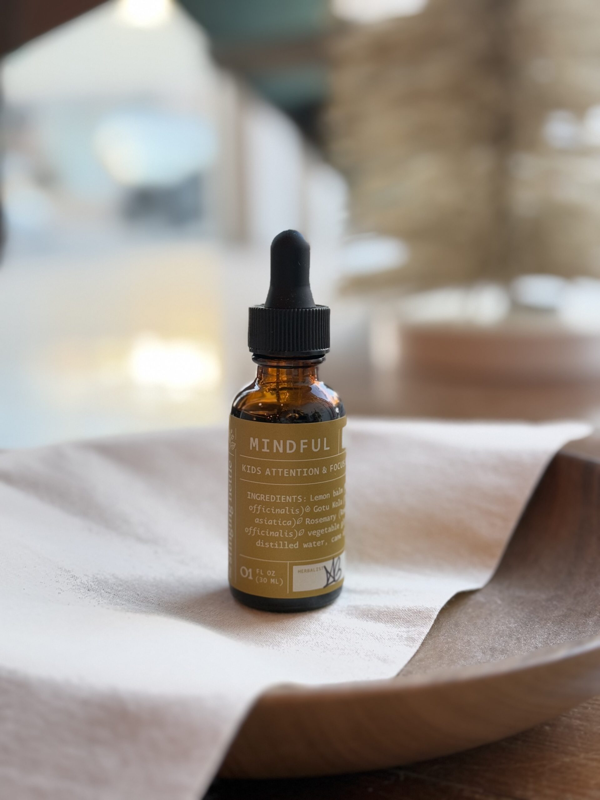 mindful kids tincture on wooden bowl